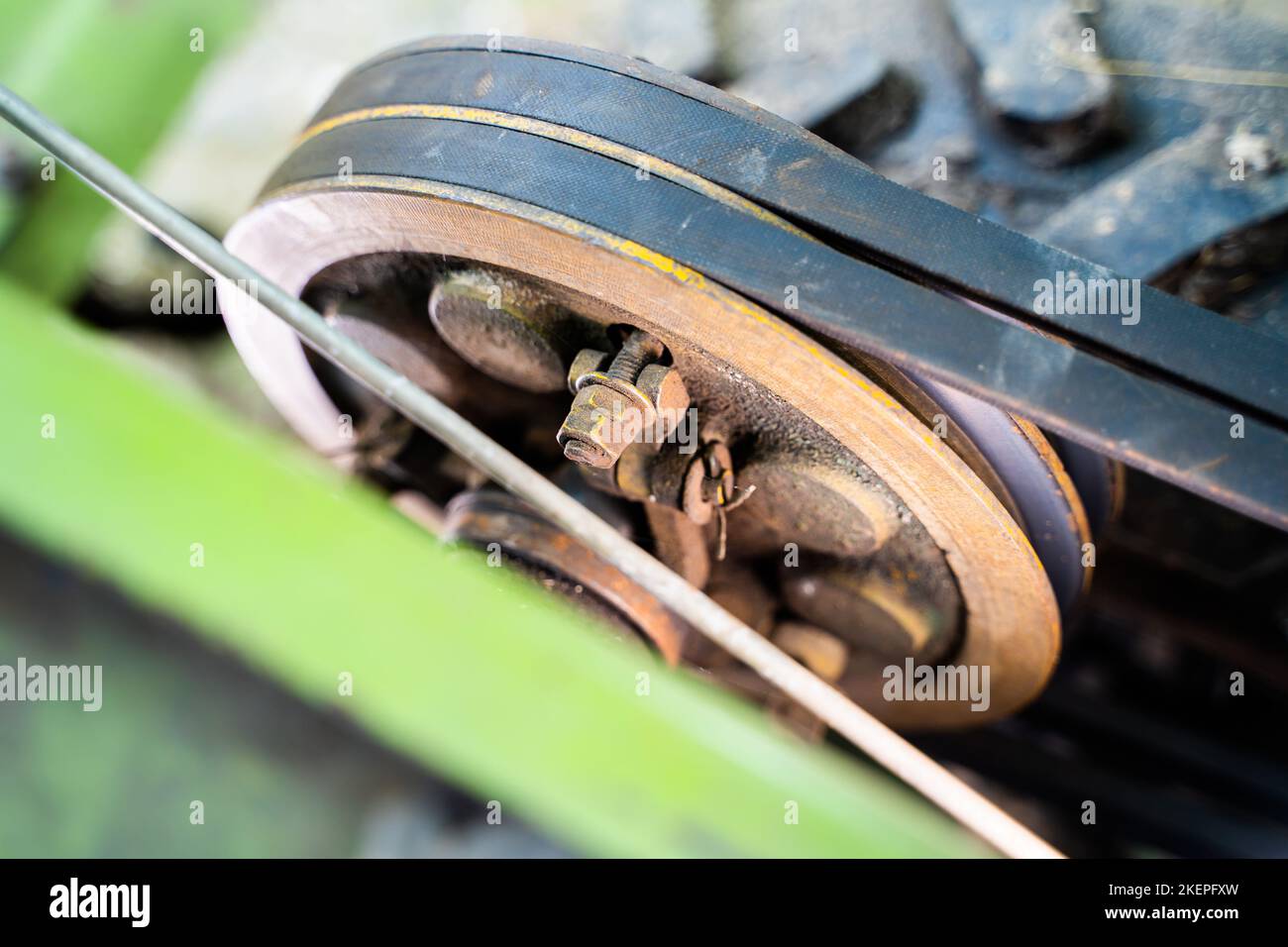 Walkbehind tractor pulley with two belts closeup. Tractor for