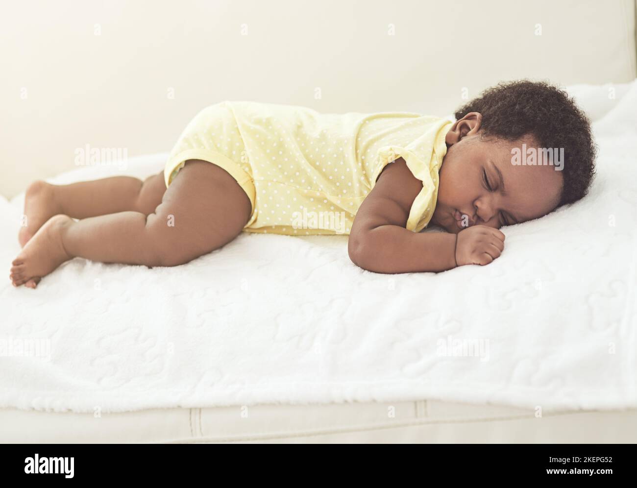 Babies need lots of rest. a baby girl asleep on a bed at home. Stock Photo