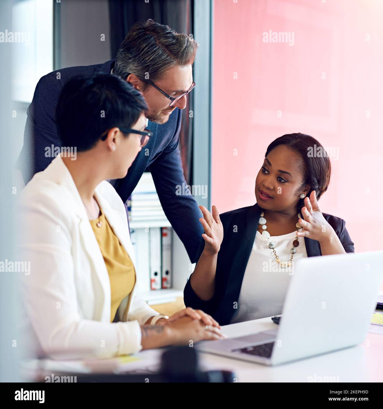 Explaining her vision. three business colleagues working in the office. Stock Photo