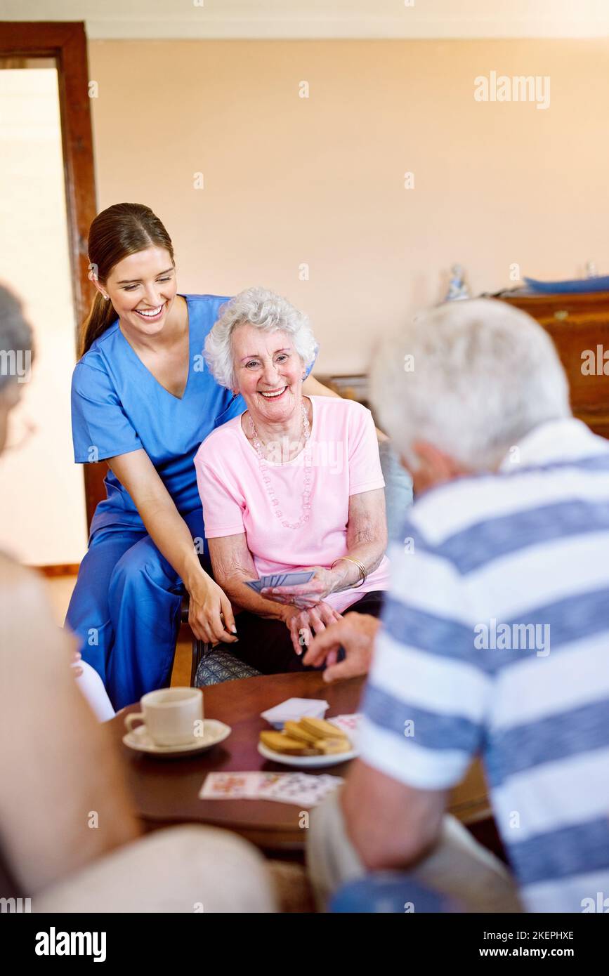 Who can beat this winning hand. a group of happy seniors playing a card