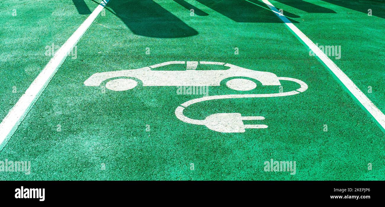 Signs for electric vehicle charging, on the ground at a charging