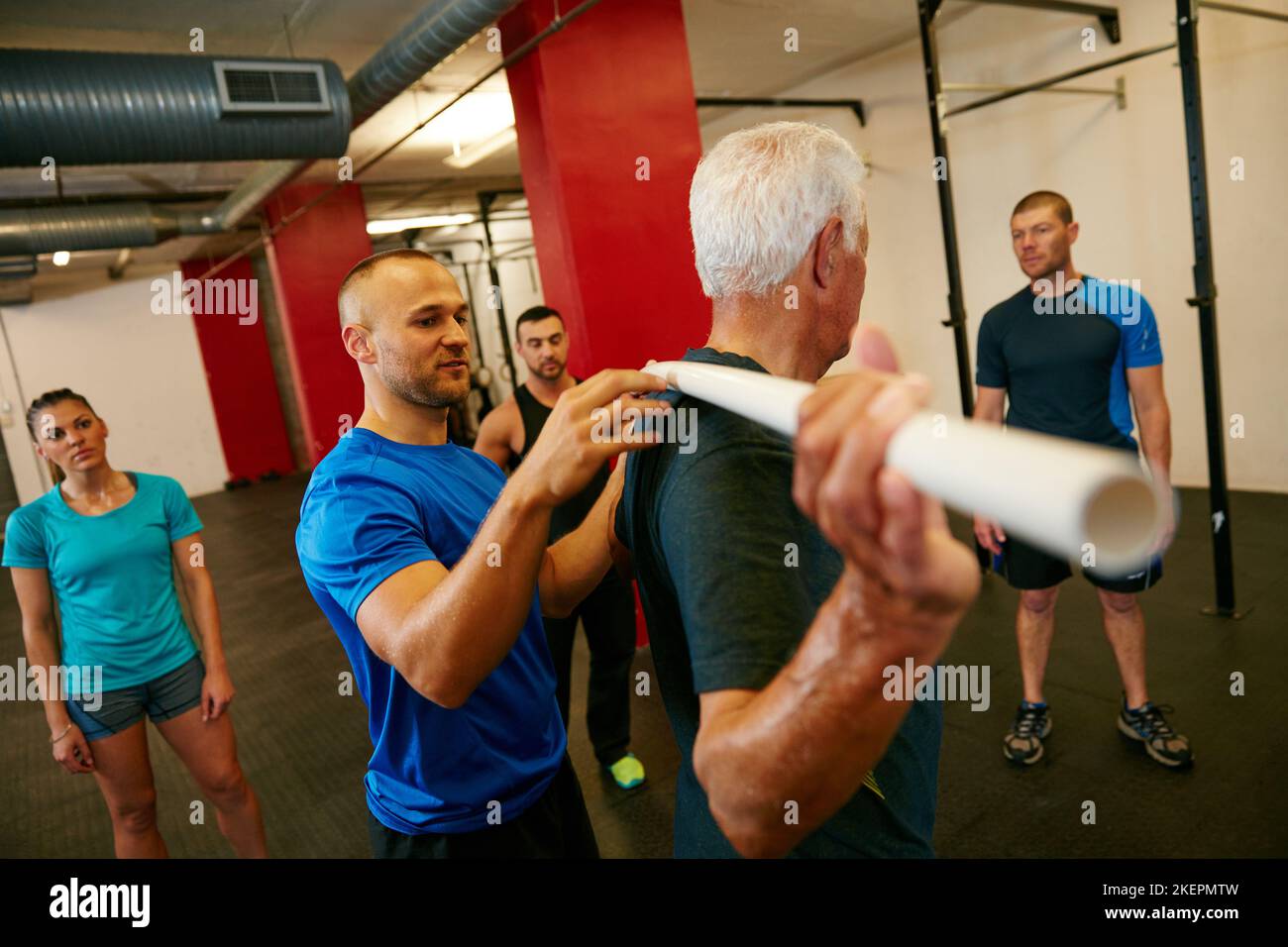 Better shoulder stability is only a pvc pipe away. a senior man doing pvc pipe exercises with