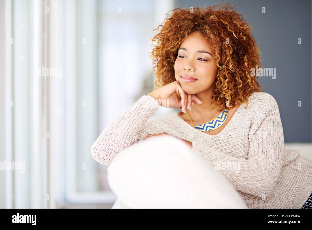Time alone is all I need right now. a young woman relaxing at home on the weekend. Stock Photo