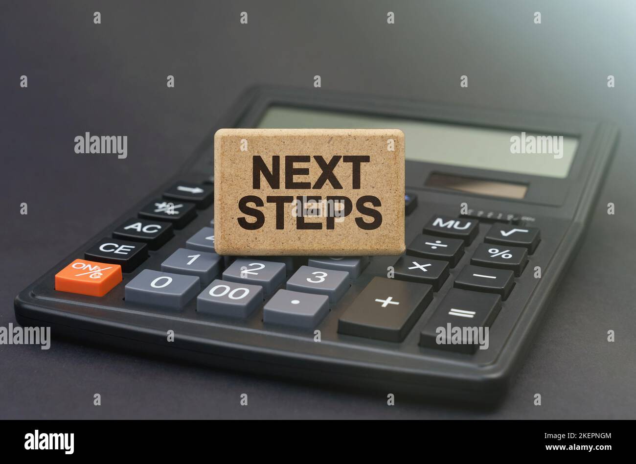 Business concept. There is a sign on the calculator that says - NEXT STEPS Stock Photo