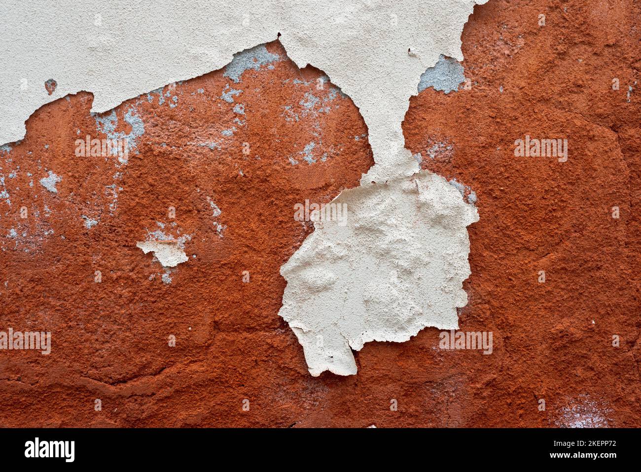 damaged paint on stucco wall detailed background Stock Photo