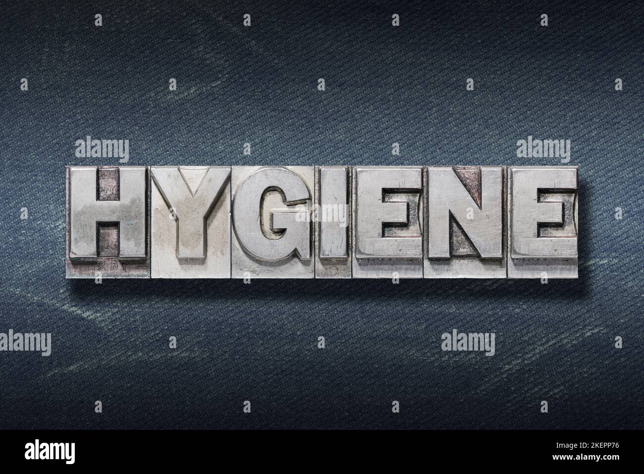 hygiene word made from metallic letterpress on dark jeans background Stock Photo