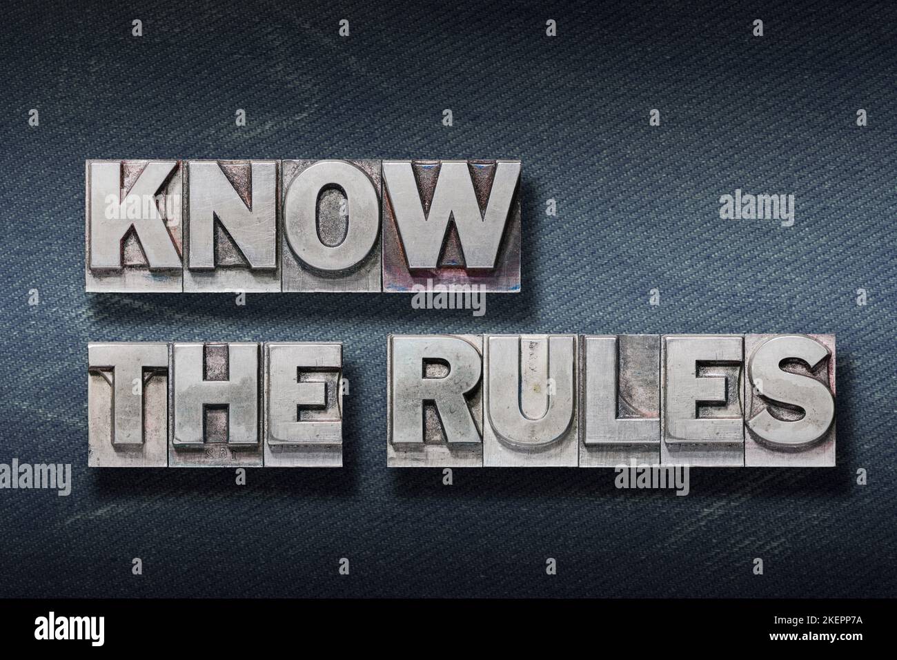 know the rules phrase made from metallic letterpress on dark jeans background Stock Photo