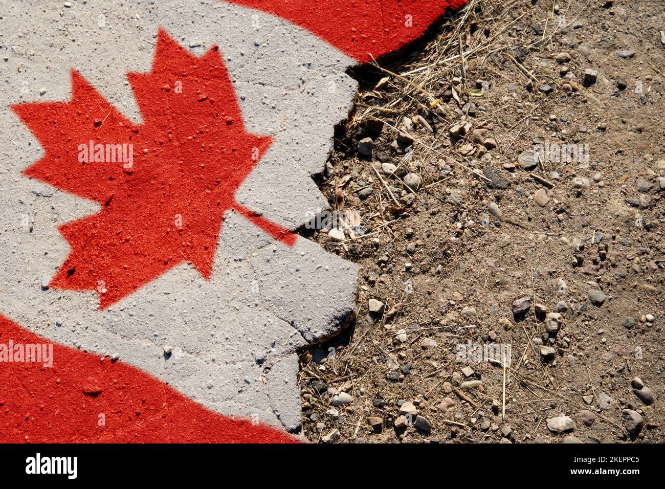 Business and politics concept. A crisis. Flag on the broken asphalt - Canada Stock Photo