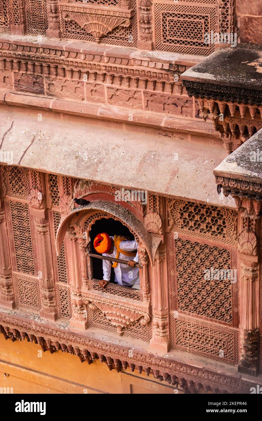 man in authentic cultural dress looking from fort window from top angle Stock Photo