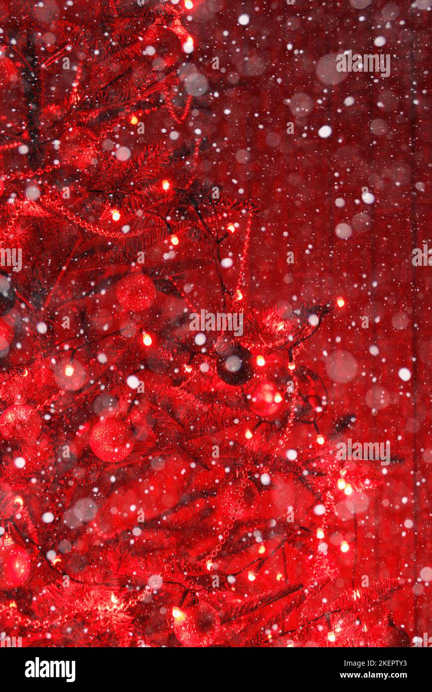 Part of a Christmas tree decorated with red lights and balls Stock Photo