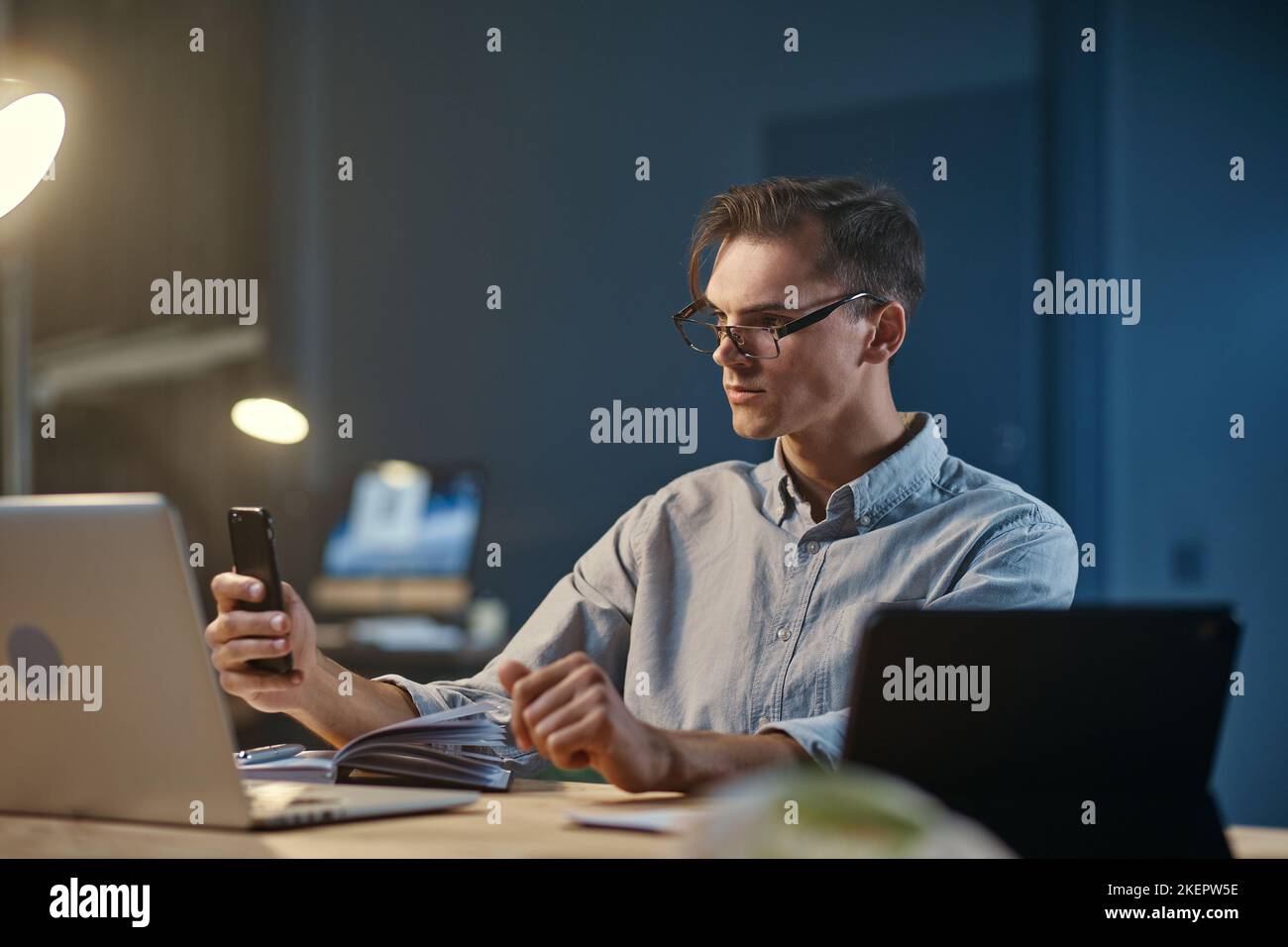 young entrepreneur taking notes in working at night. Stock Photo