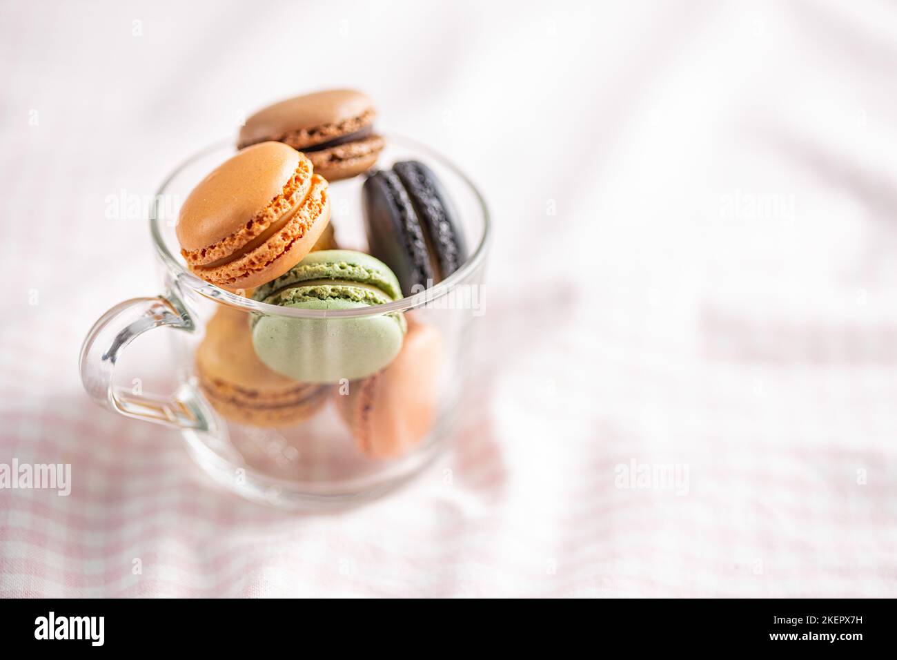 Sweet macaron dessert. Colorful macarons in the cup. Stock Photo
