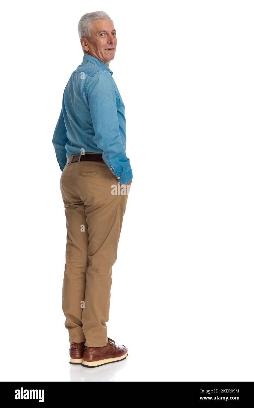 full body picture of good looking old man with hands in pockets looking