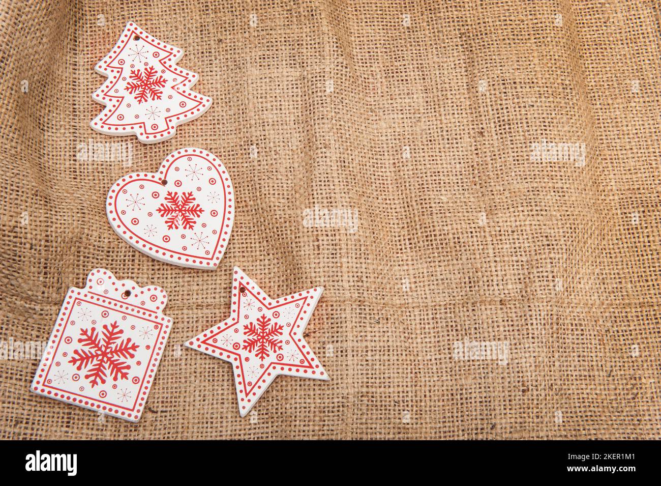 Wooden Christmas decorations on a background of burlap with artificial snow Stock Photo