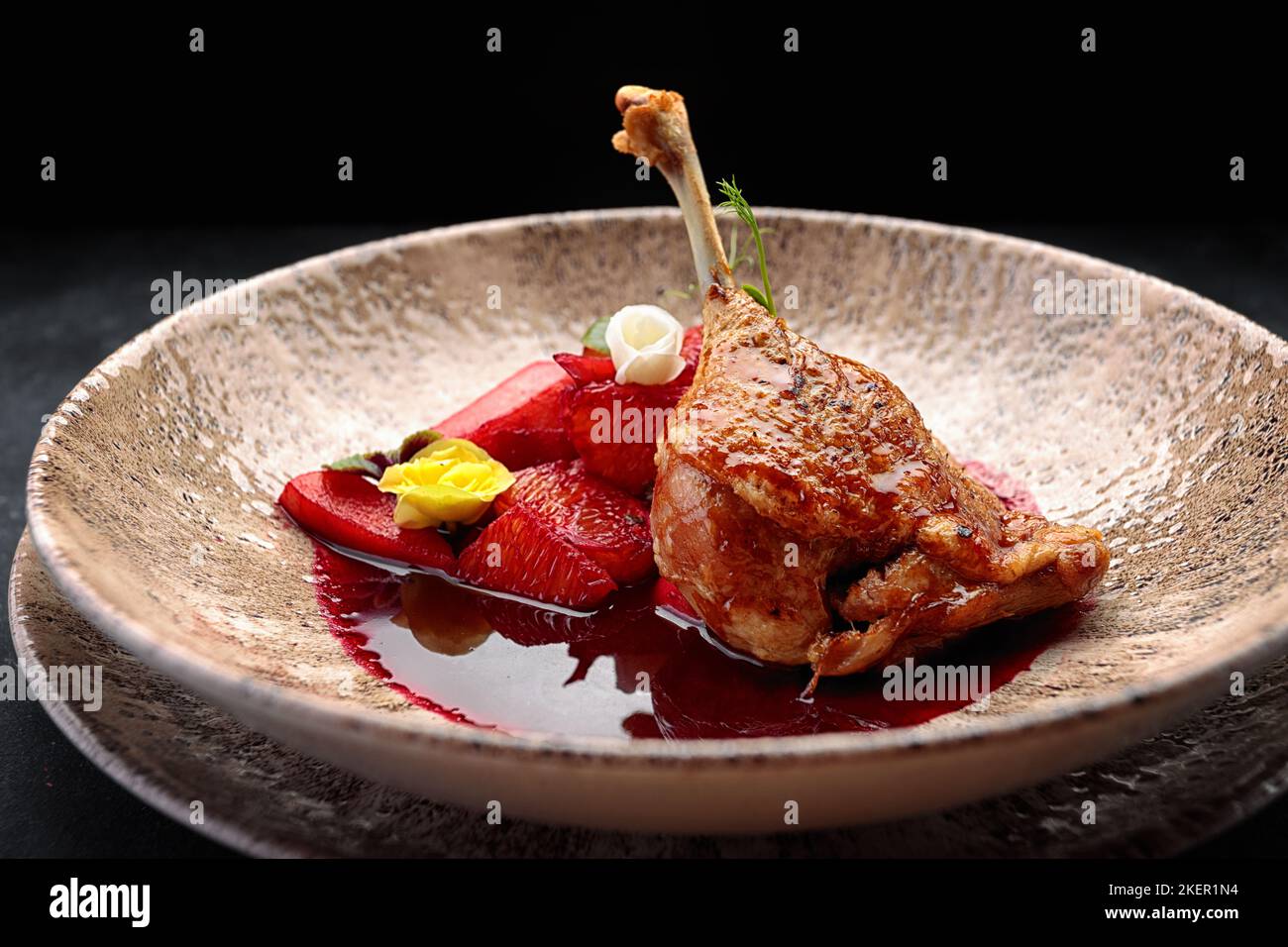 Baked duck leg in sauce with oranges Stock Photo - Alamy