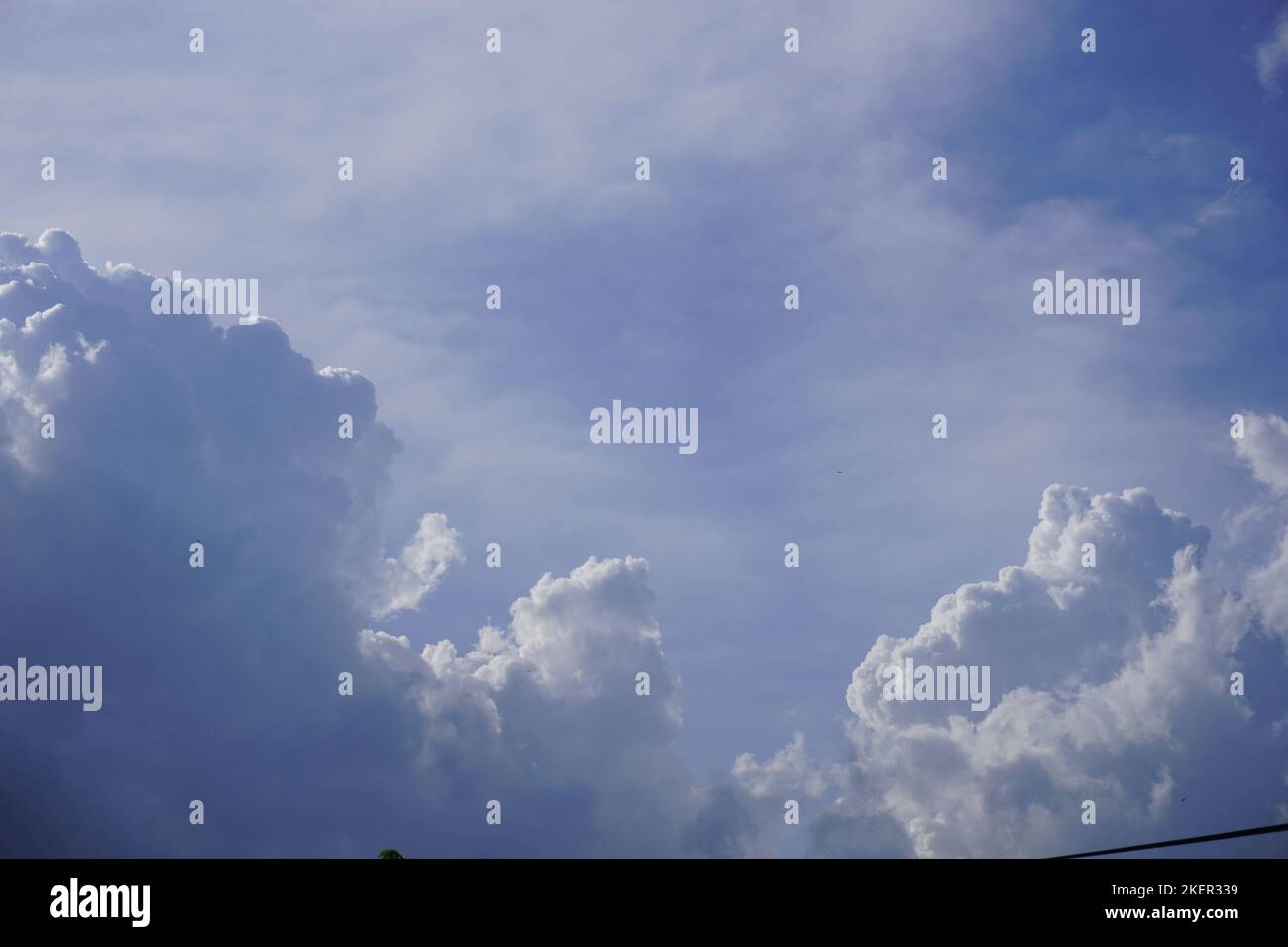 Blue sky with dense white clouds on a sunny day for abstract background and template Stock Photo