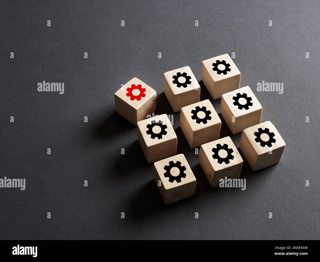Breakdown in the production system, deviation from the norms, broken part or violation of order, malfunction failure. Wooden cubes with production pro Stock Photo