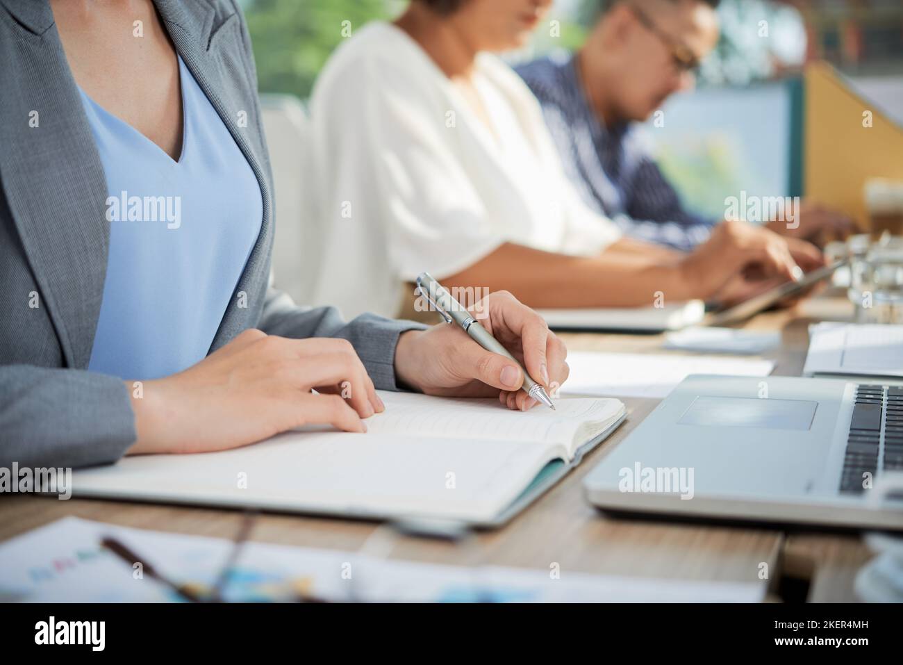 Cropped image of business lady writing her ideas in notepad Stock Photo