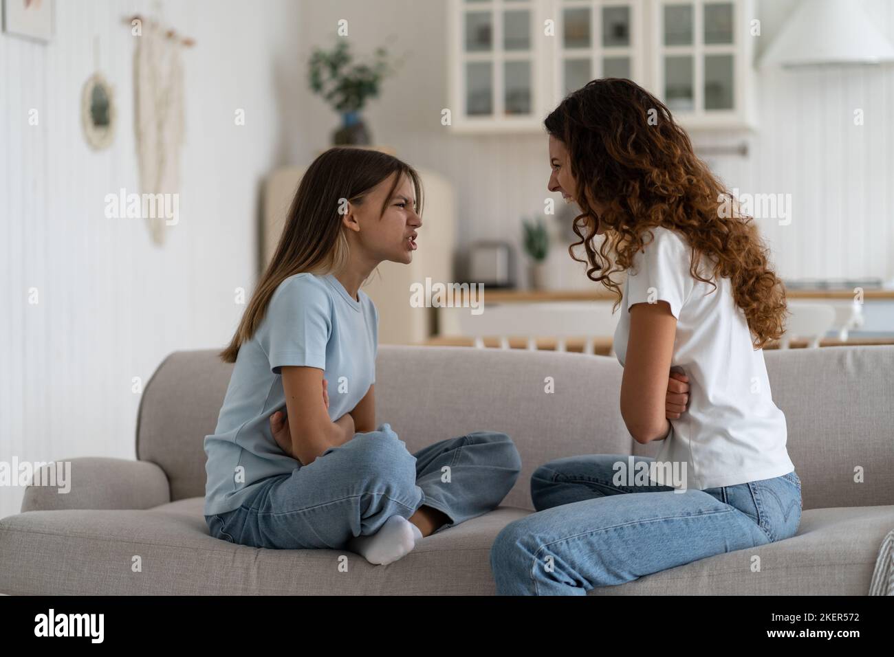 Parent-Teen misunderstandings. Disrespectful child daughter arguing quarreling with mom at home.  Stock Photo