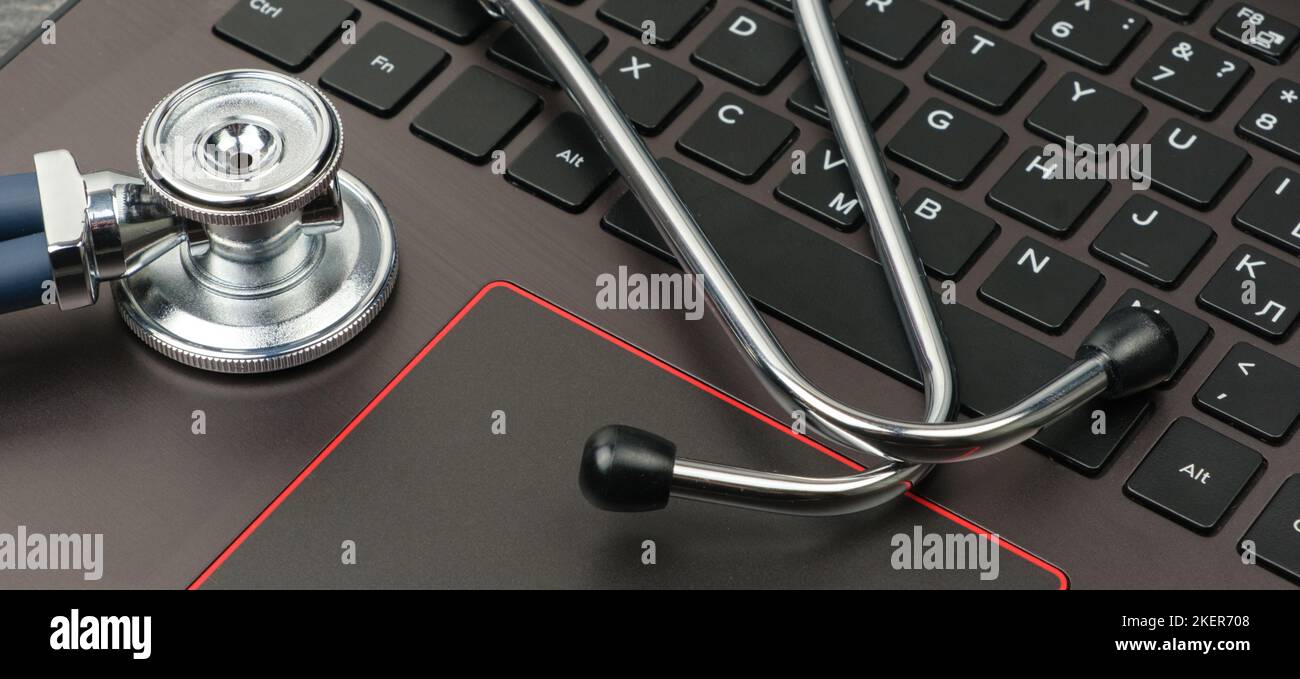 Silver stethoscope on a modern laptop keyboard. Medical concept Stock ...