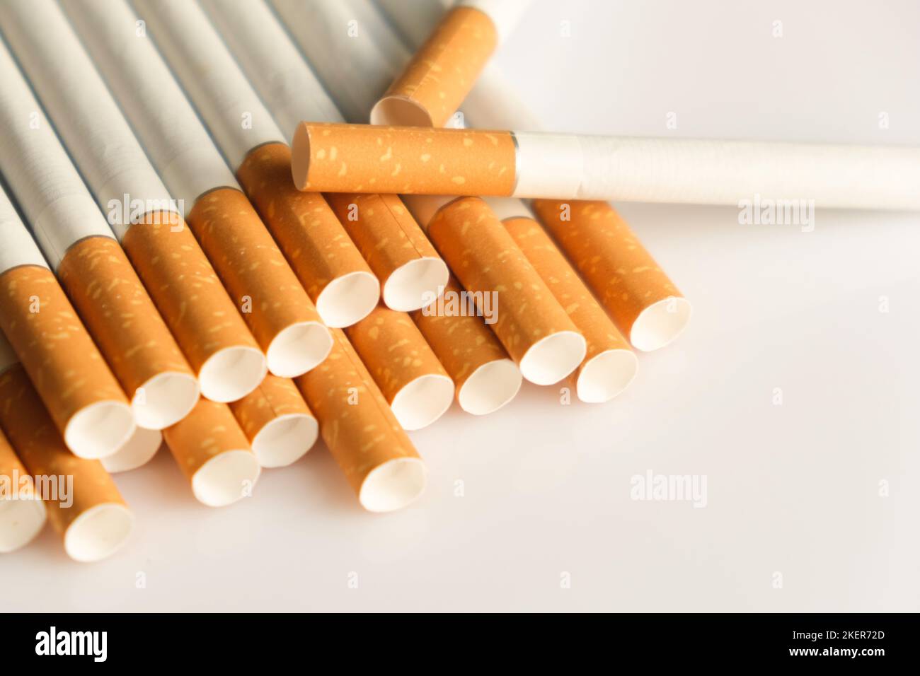 Medicine concept. Cigarettes with a yellow filter lie on a white