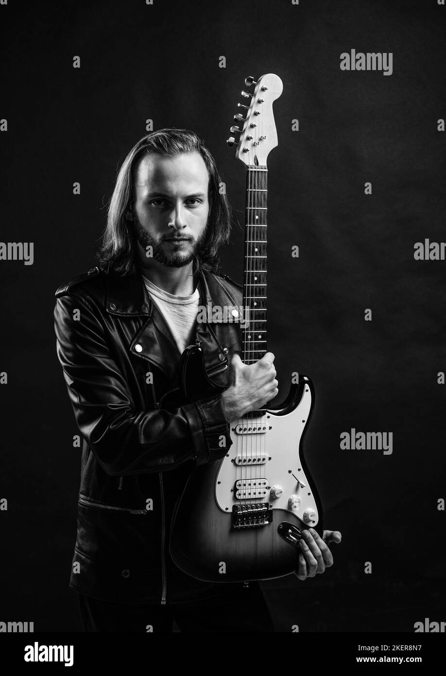 presenting product. string musical instrument. bearded rocker. Stock Photo