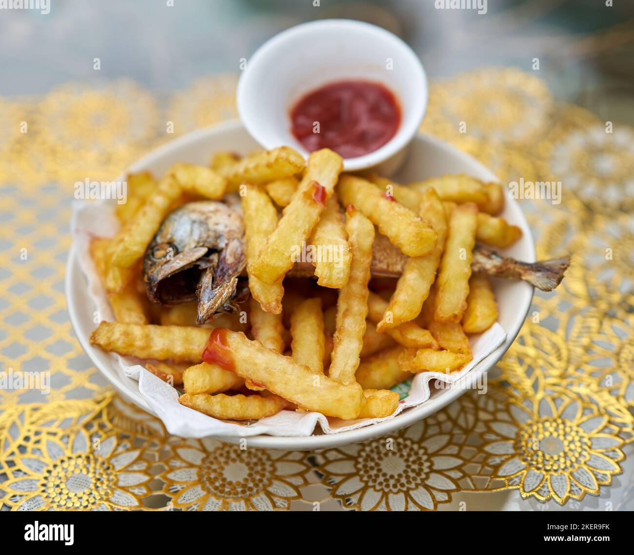 A plate of fish and chips with tomato ketchup. Stock Photo