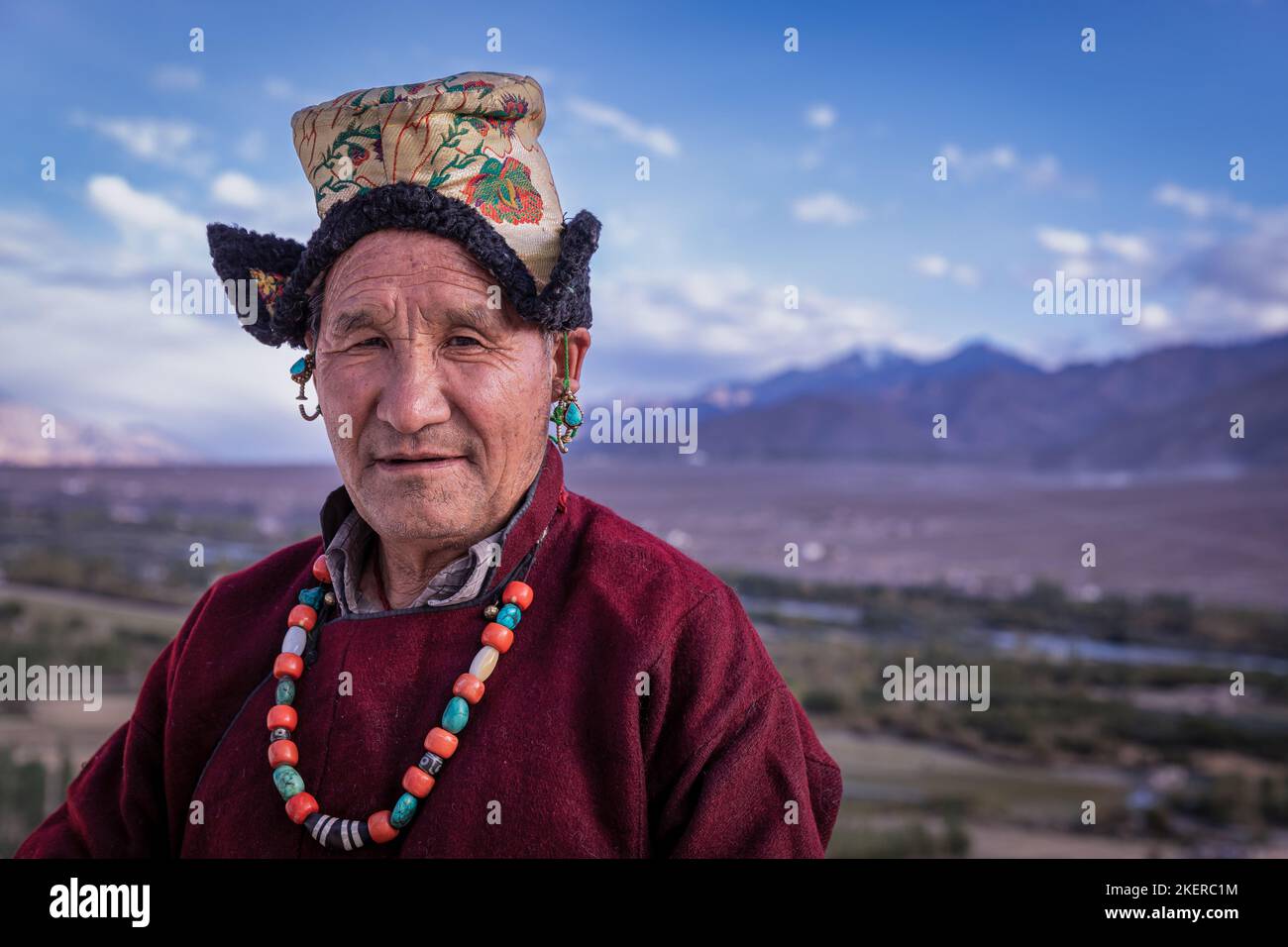Elderly man in traditional Ladakhi clothes, Spituk Monastery (Gompa), Leh district, Ladakh, India Stock Photo