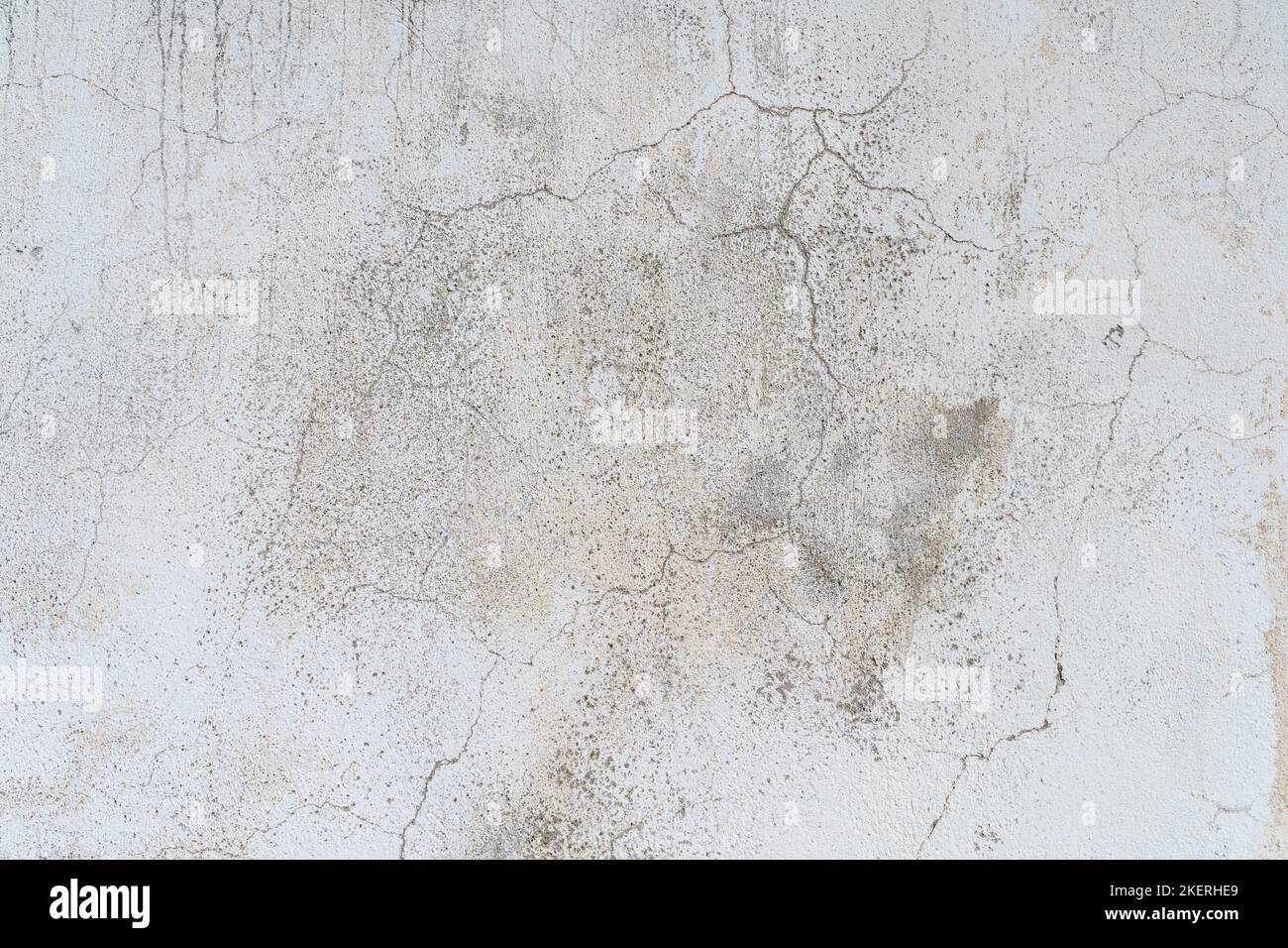 Old concrete stone wall covered with cracked plaster and dirty grunge textured surface. High quality photo Stock Photo