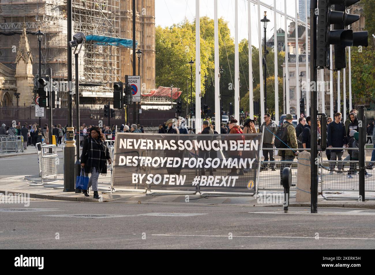Banner ('Never has so much been destroyed for so many by so few') from a protest group protesting against Brexit next to Parliament, London 09.11.22 Stock Photo