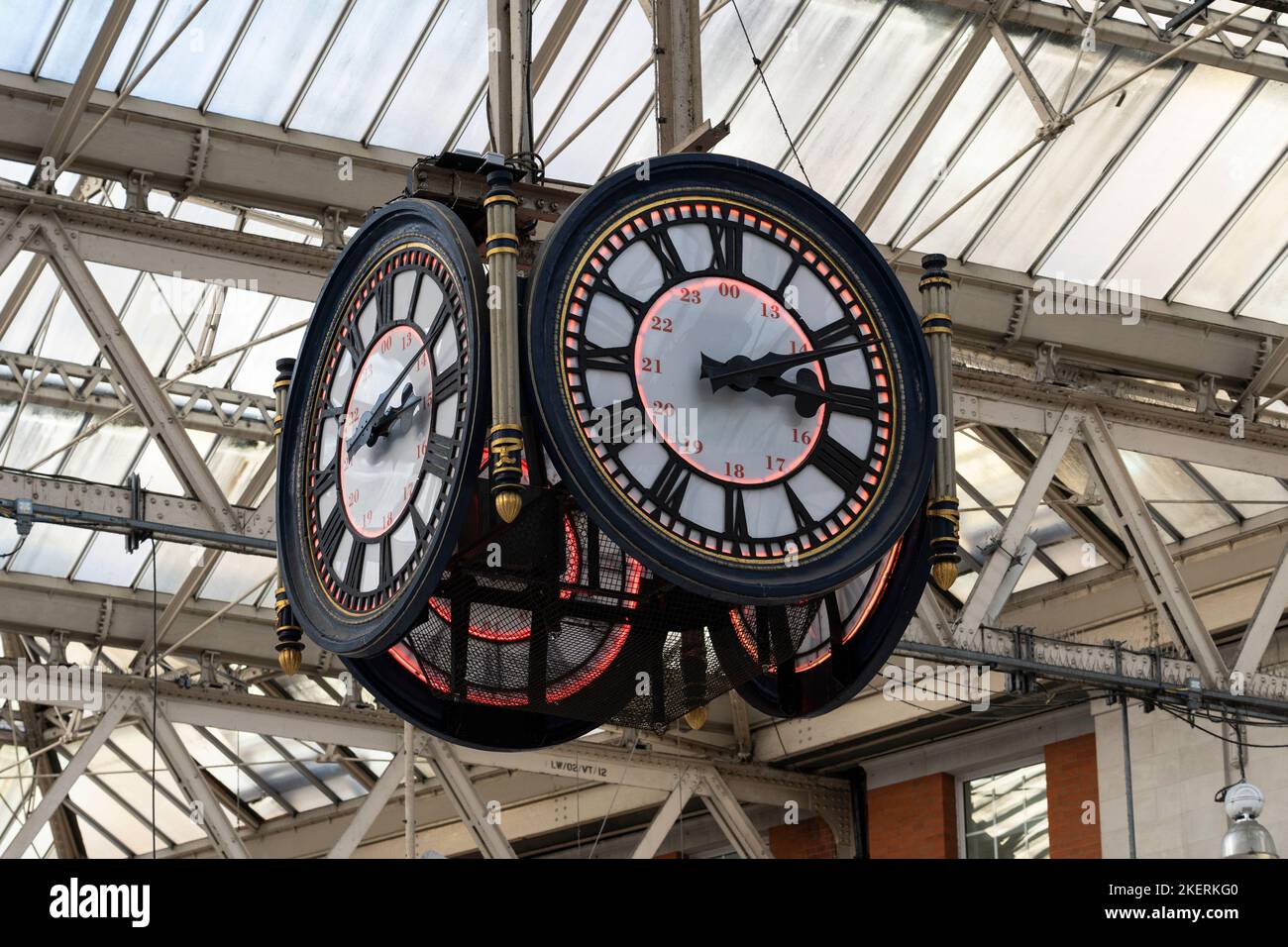 The four sided hanging clock at Waterloo train station hangs above the main concourse and is a favourite spot for romantics to meet. London, England Stock Photo