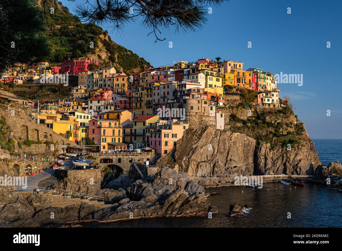 A beautiful view of the Italian village Manarola with blue sky and colorful buildings. Stock Photo