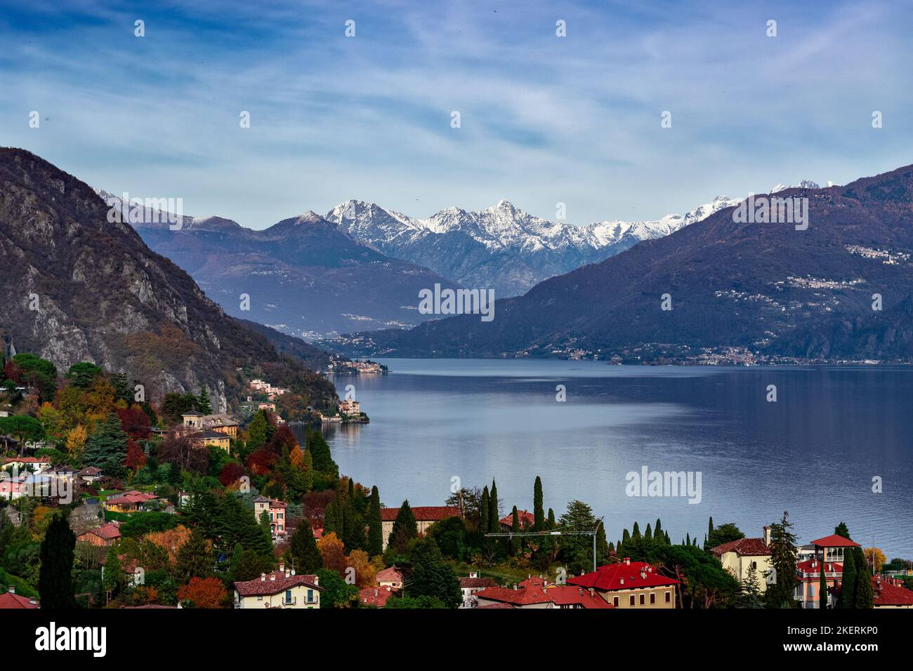 A beautiful scene of Lake Como with the Alps and colorful trees in the distance. Stock Photo