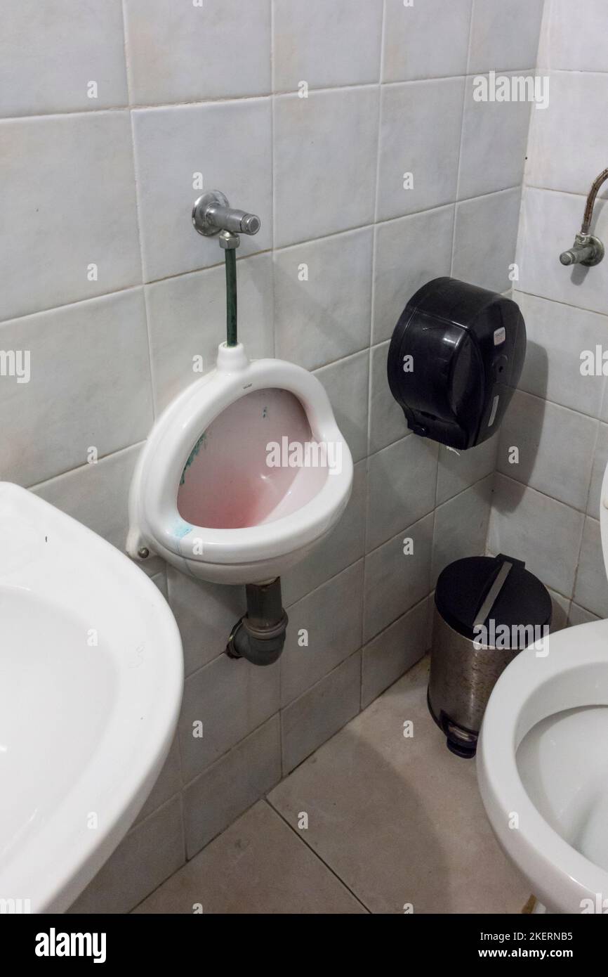 Space saving urinal in cafe, Tavira, Algarve, Portugal Stock Photo