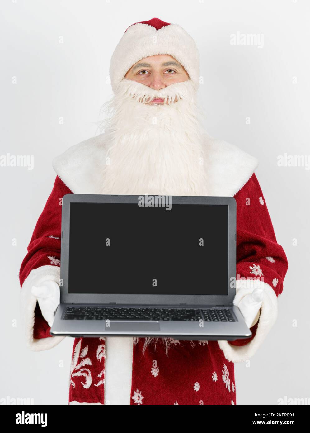 Christmas and New Year concept. Santa Claus sits at his desk and works ...