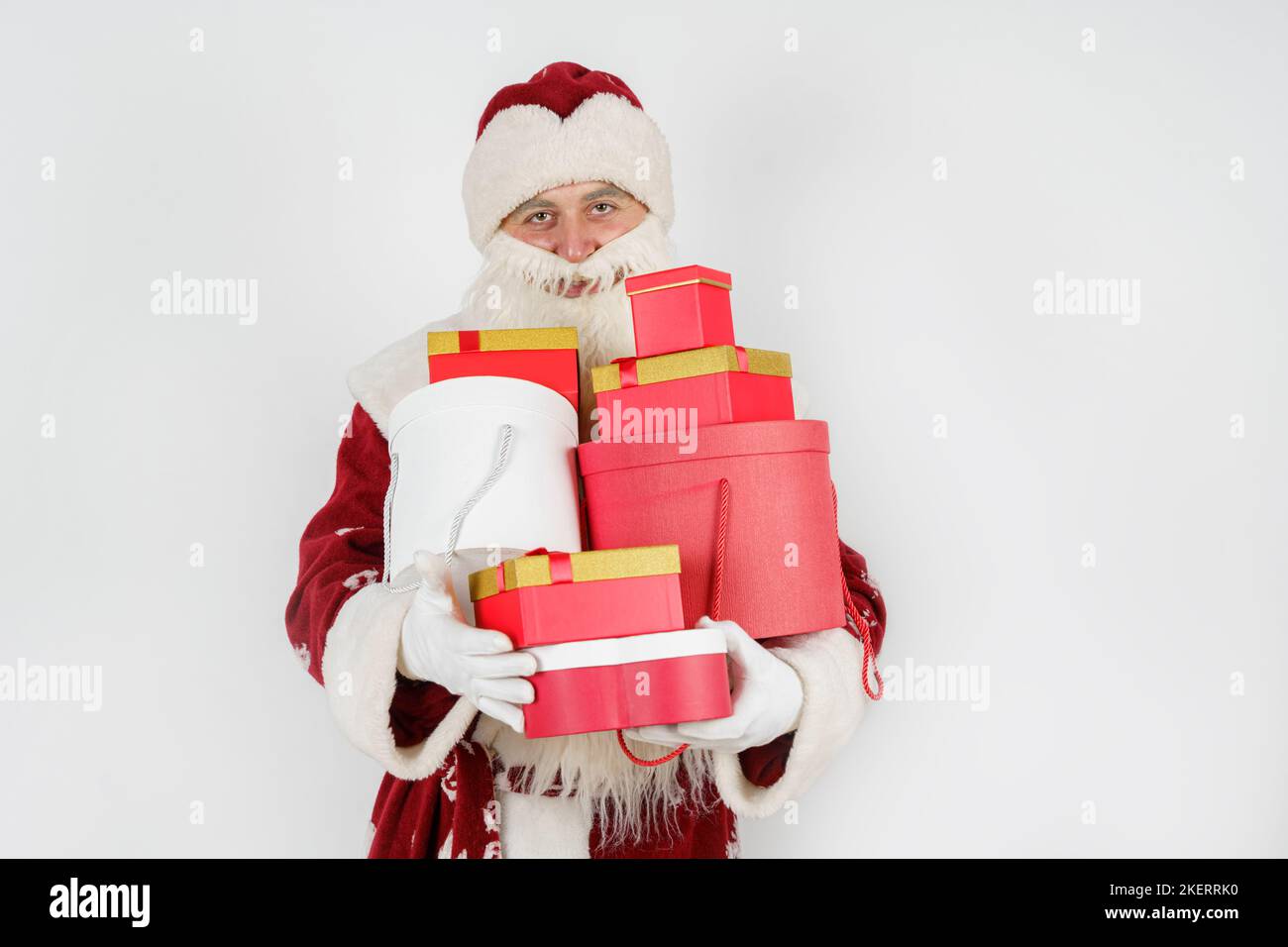 Holidays and Christmas concepts. Santa Claus holds gifts in his hands ...