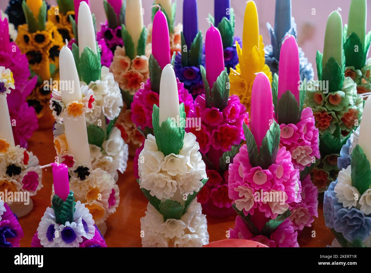 Fancy candles with elaborate wax flowers made by hand in a in