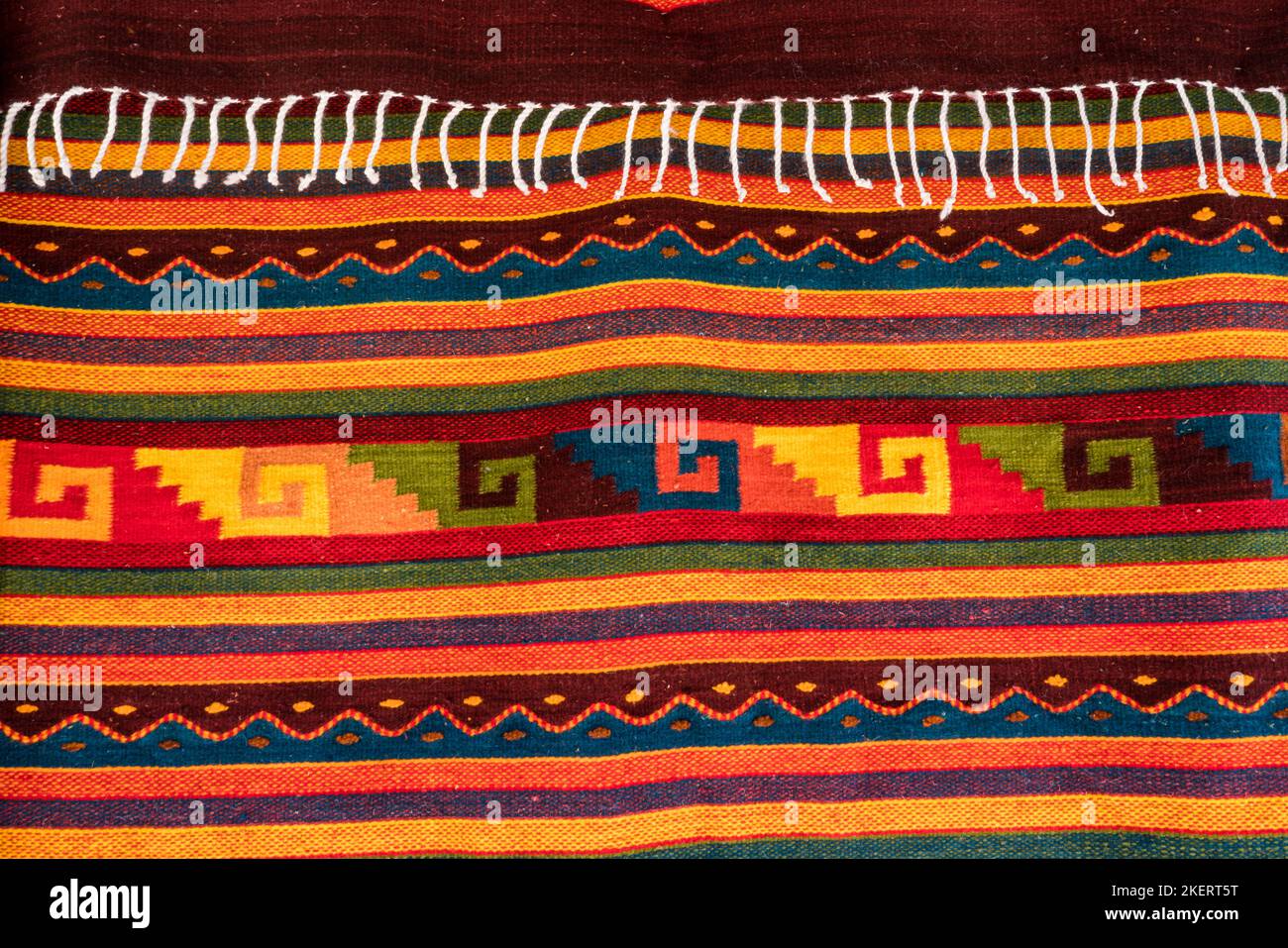 A handwoven wool rug with Zapotec designs for sale on the street in