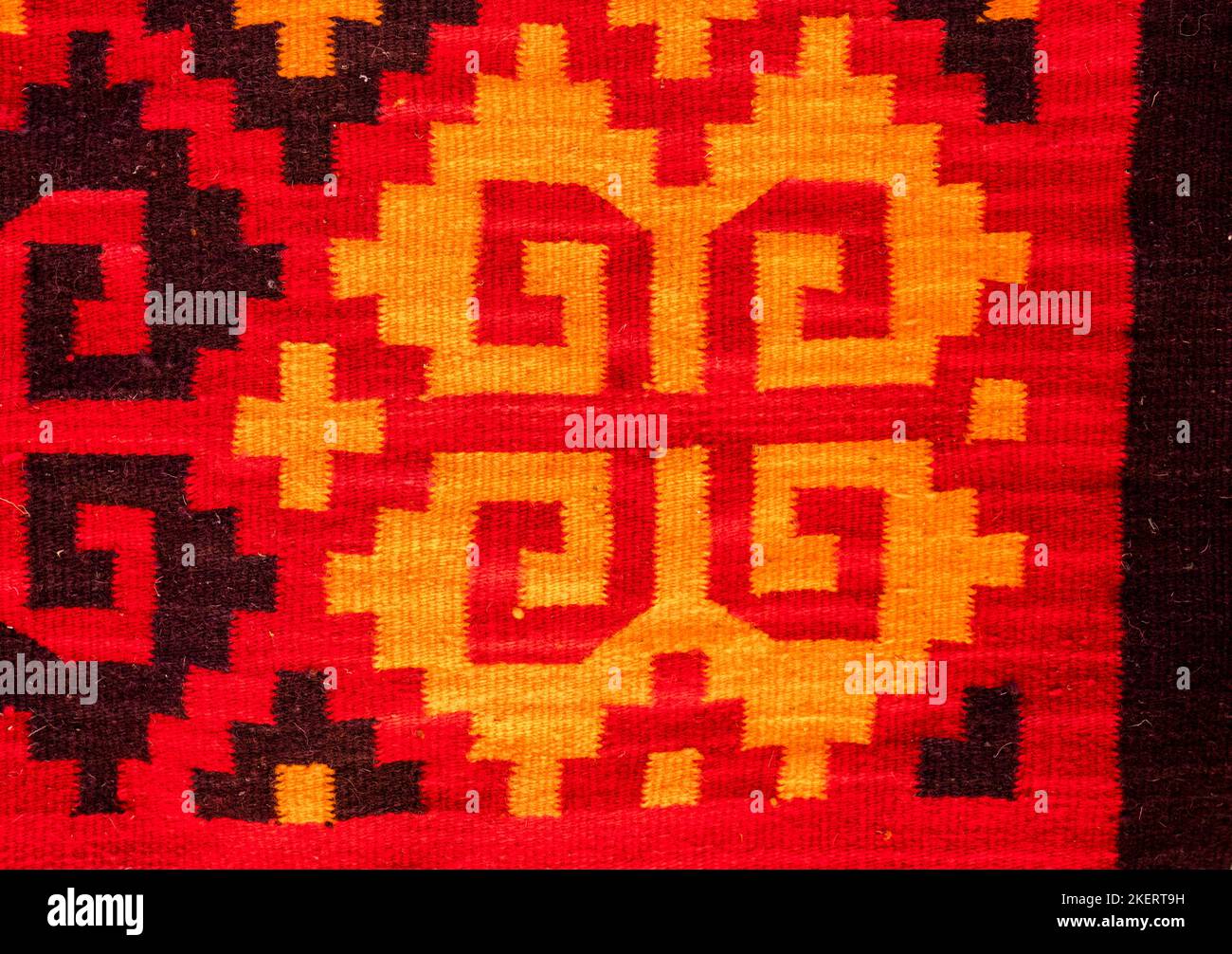 Handwoven wool rugs with Zapotec designs for sale on the street in