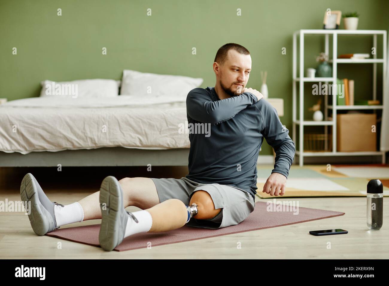 Man stretching leg on floor hi res stock photography and images Alamy