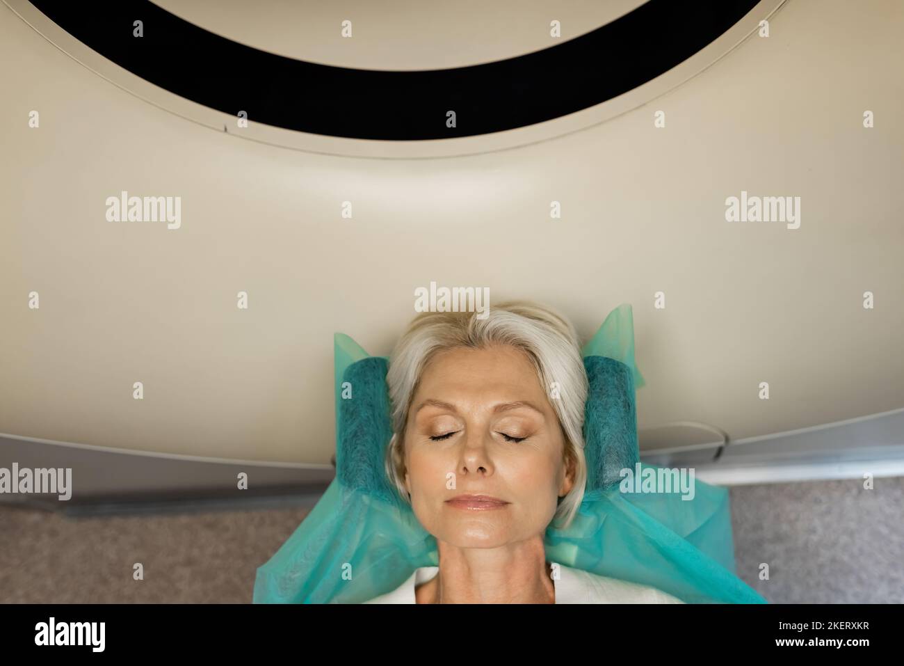 top view of blonde woman making diagnostics on computed tomography ...