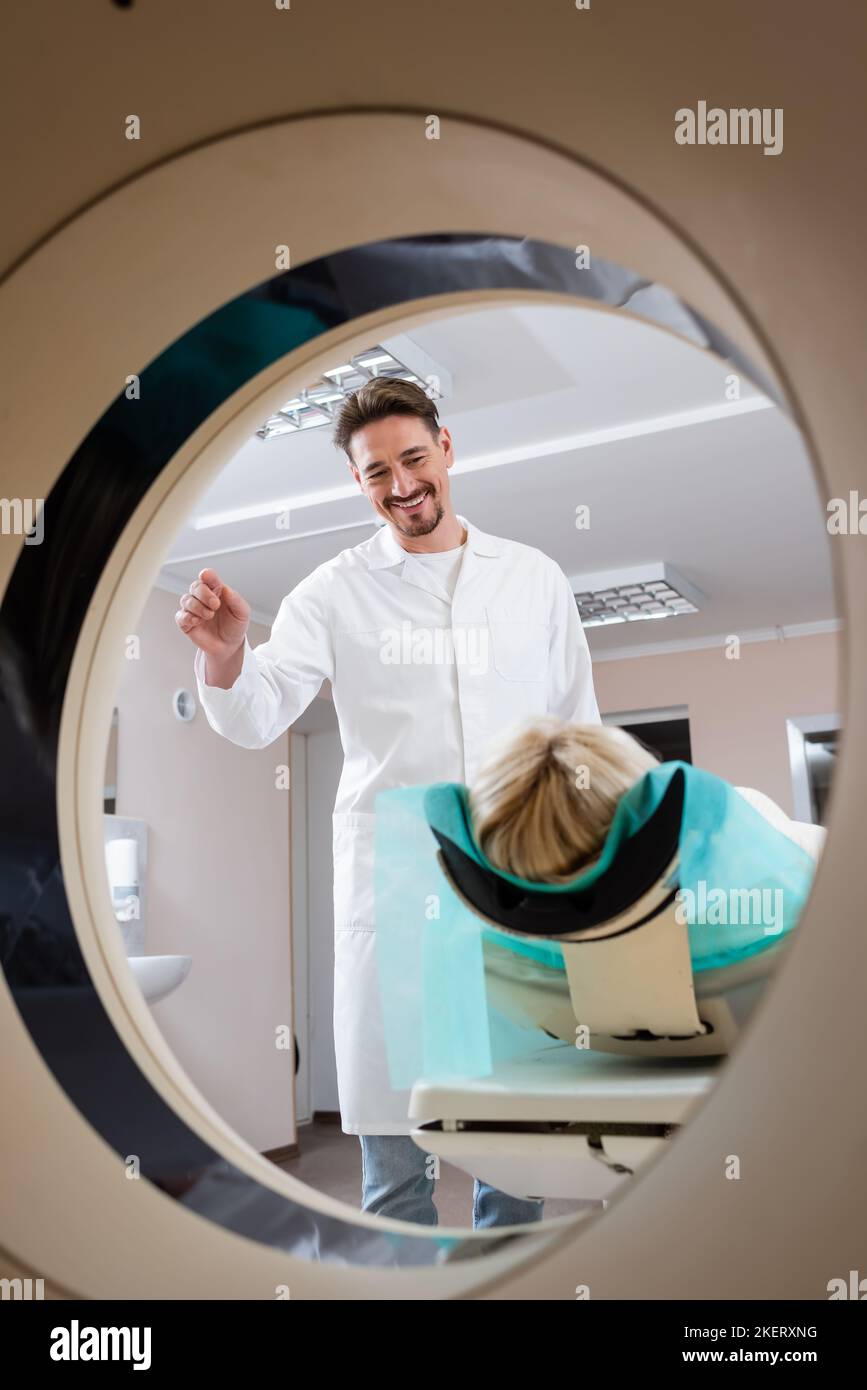 positive radiologist smiling at patient before procedure of computed ...