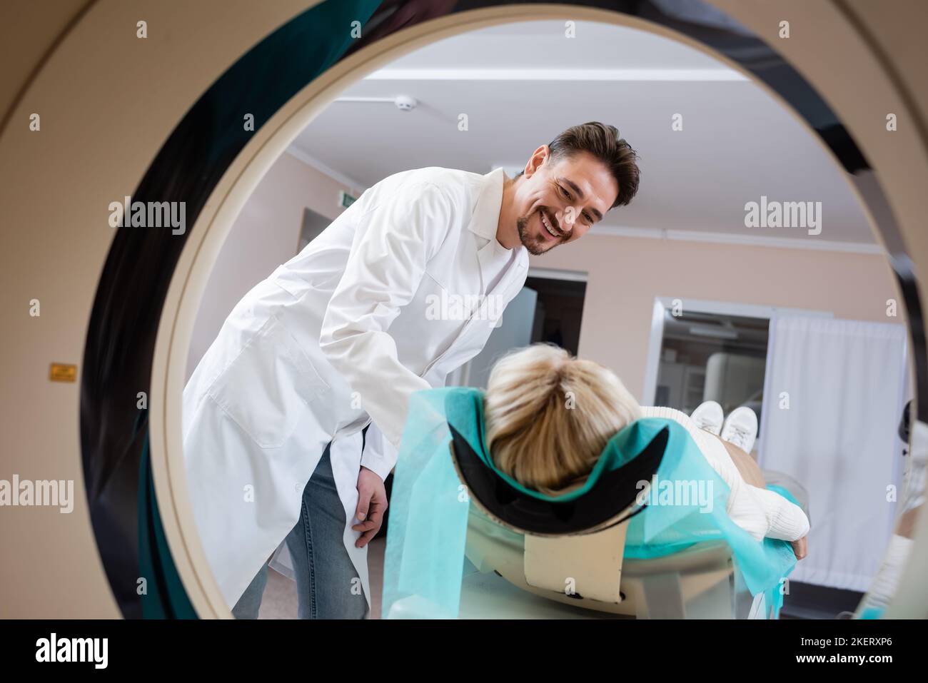 radiologist smiling at woman during computed tomography in hospital ...