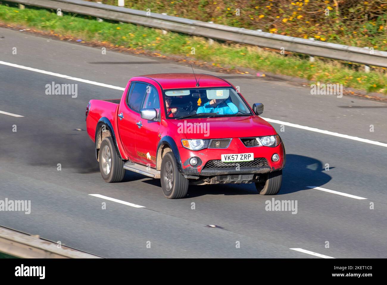 2007 Red MITSUBISHI L200 4WD SHR 4LIFE DCB 2477cc 5 Speed manual pick-up truck, emitting black exhaust smoke & diesel particles from damaged engine travelling on the M61 Motorway UK Stock Photo