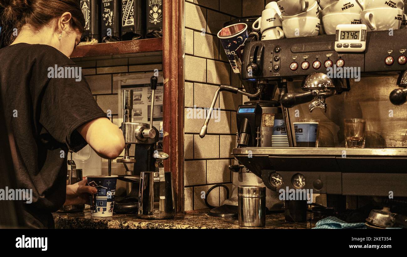 Epsom Surrey, London UK, November 14 2022, Young Woman Barista Making Coffee In A High Street Cafe Nero Coffe Shop Stock Photo