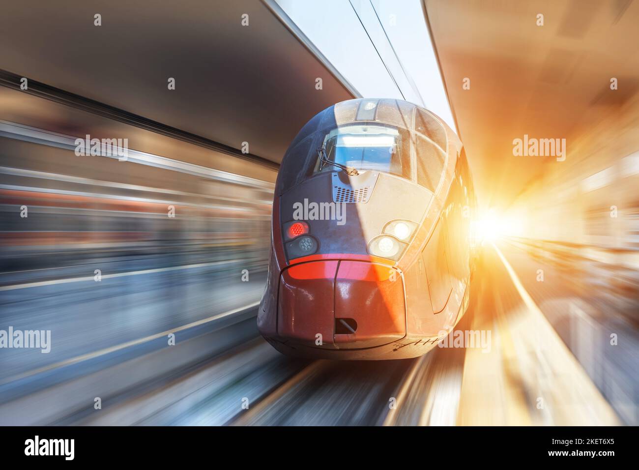 Modern high speed train on a clear day with motion blur at the city ...