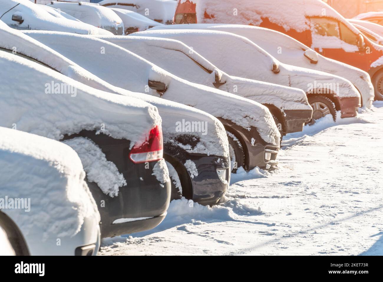 Cars covered in snow on a parking lot in the residential area Stock ...