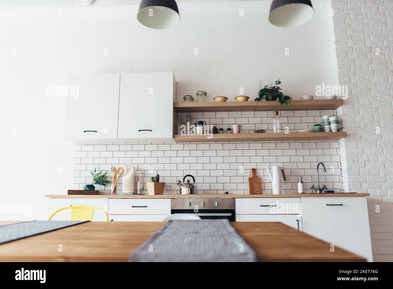 Modern new light interior of kitchen with white furniture and dining ...