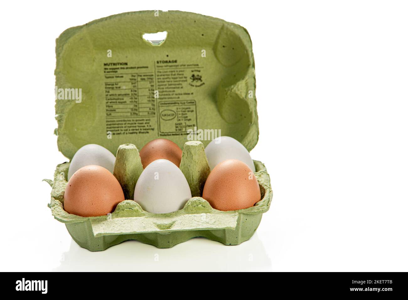 An open carton of mixed white and brown eggs Stock Photo