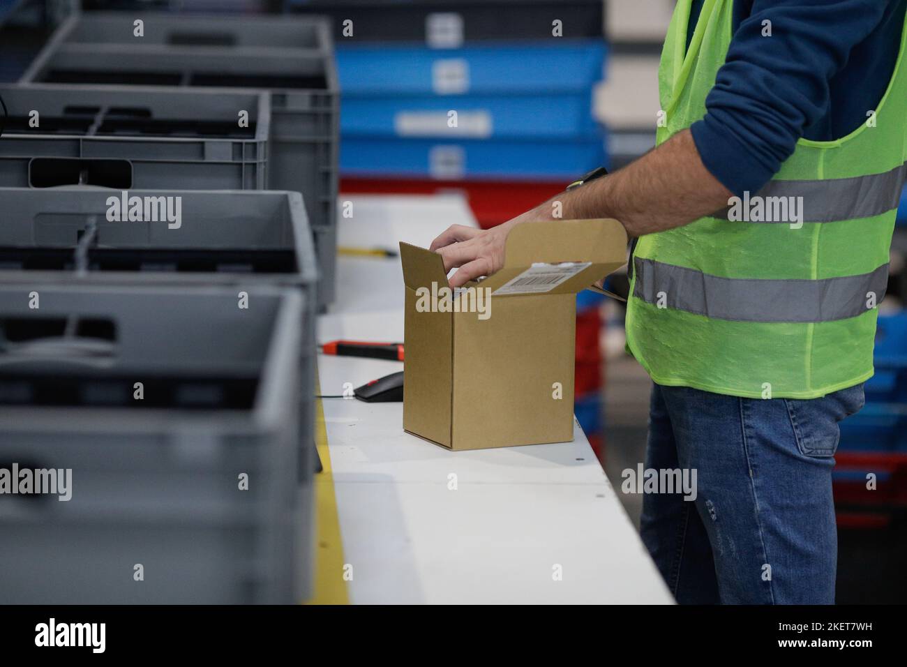 Bucharest, Romania - November 7, 2022: Shallow depth of field (selective focus) details a man working in an e-commerce and delivery company. Stock Photo